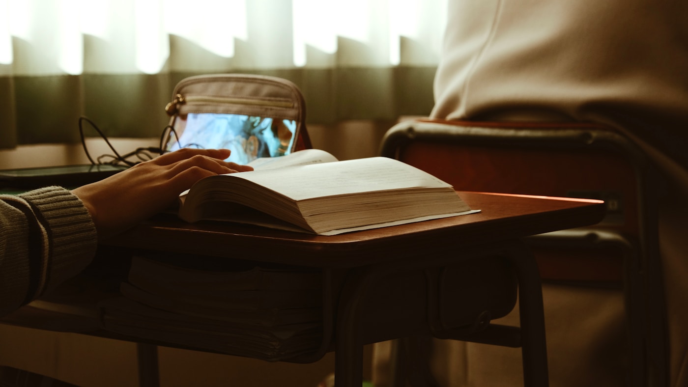 Studying a driver's handbook at a desk