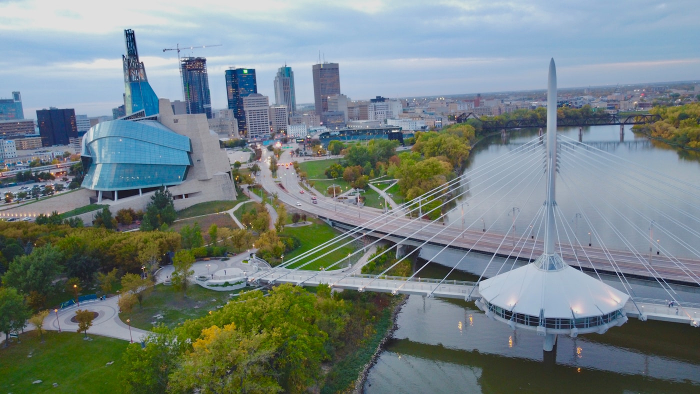 Aerial view of downtown Winnipeg with the Canadian Museum for Human Rights and the Esplanade Riel bridge over the Red River