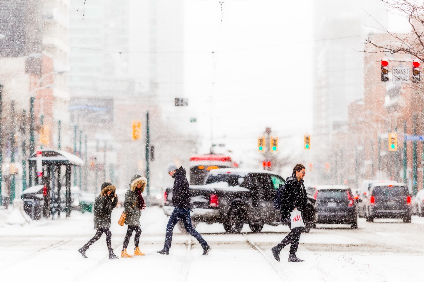 People crossing a downtown Toronto street during a heavy February snowfall