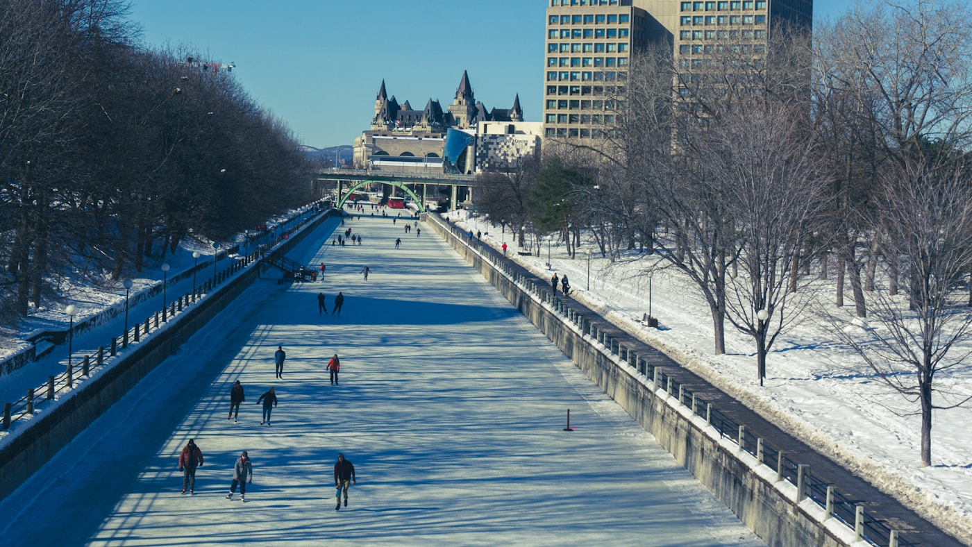 Skaters on the Rideau Canal Skateway in Ottawa, with the Château Laurier in the background